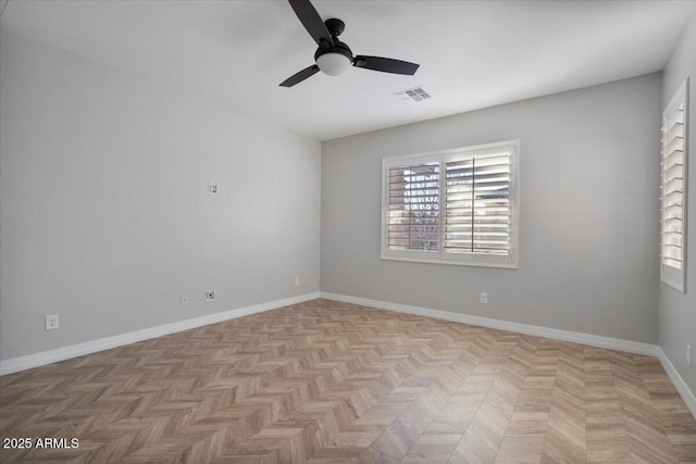 unfurnished room with ceiling fan and light parquet floors