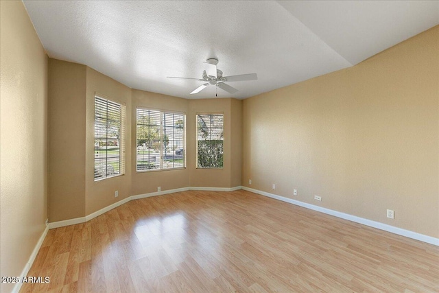 spare room featuring ceiling fan and light hardwood / wood-style flooring