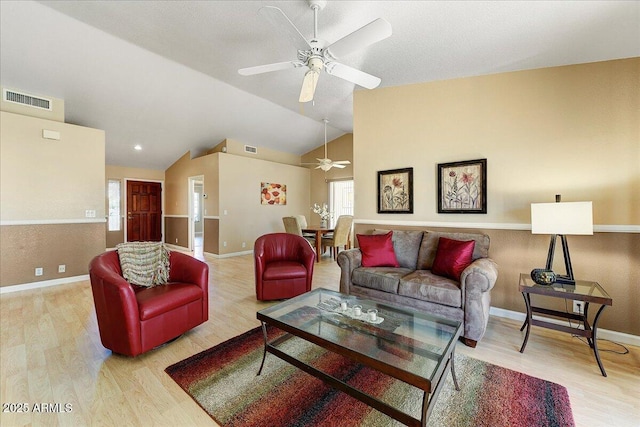 living room with lofted ceiling, ceiling fan, and light hardwood / wood-style flooring