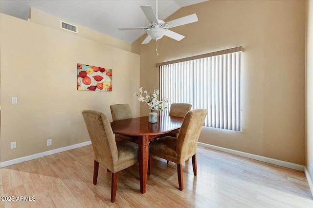 dining room featuring vaulted ceiling, light hardwood / wood-style floors, and ceiling fan