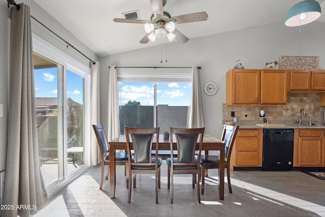 dining room featuring sink, vaulted ceiling, and ceiling fan