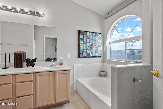 bathroom with tile patterned flooring, vanity, and a washtub