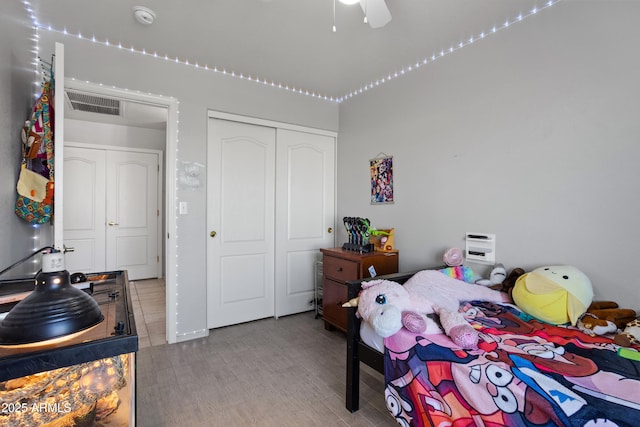 bedroom with ceiling fan, a closet, and light hardwood / wood-style flooring