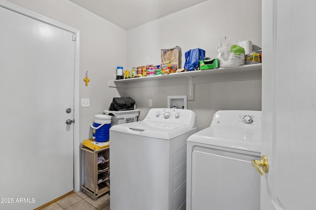 laundry room with independent washer and dryer and light tile patterned floors