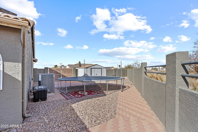 exterior space featuring a trampoline and a patio