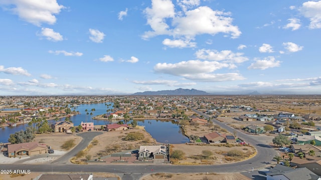 birds eye view of property with a water and mountain view