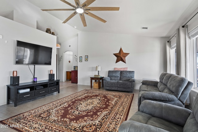 living room featuring ceiling fan and vaulted ceiling