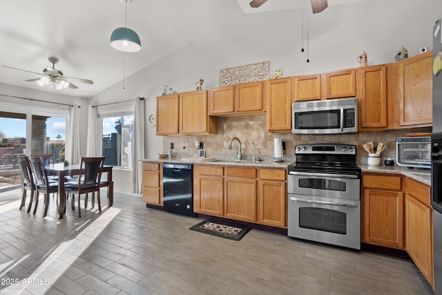 kitchen with pendant lighting, tasteful backsplash, sink, ceiling fan, and stainless steel appliances