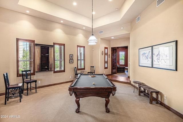 playroom with a towering ceiling, billiards, a tray ceiling, and light colored carpet