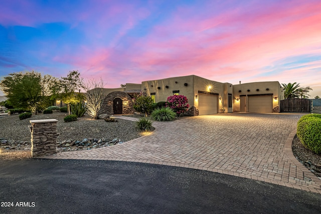 pueblo-style house with a garage