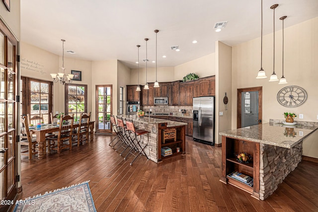 kitchen featuring decorative light fixtures, dark hardwood / wood-style floors, and stainless steel appliances