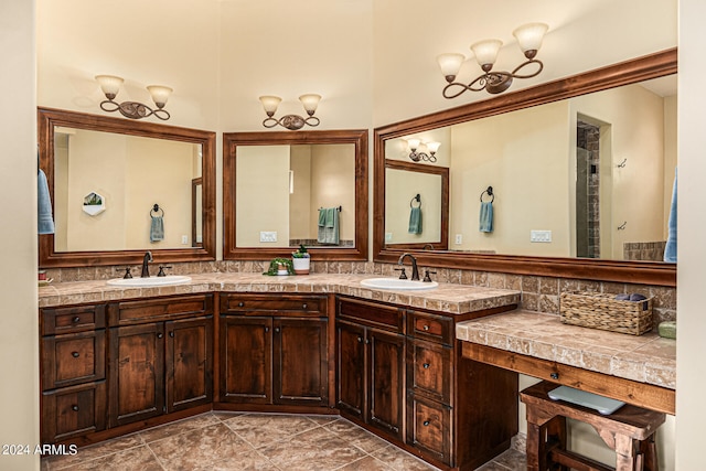 bathroom featuring tile patterned flooring, double sink vanity, and backsplash