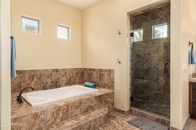 bathroom featuring independent shower and bath, tile patterned flooring, and vanity