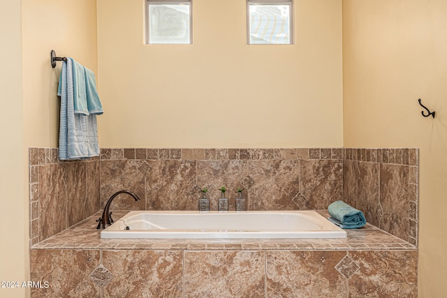 bathroom with a relaxing tiled tub