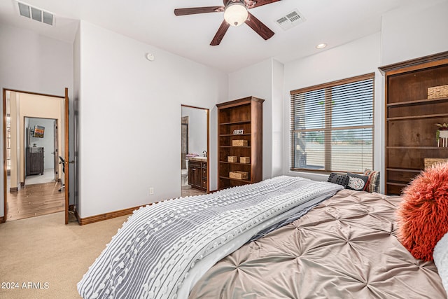 carpeted bedroom with ceiling fan and connected bathroom