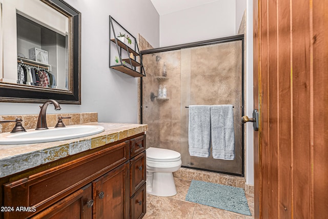 bathroom featuring tile patterned floors, vanity, walk in shower, and toilet