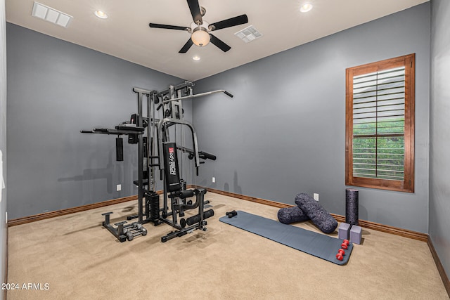 workout room with carpet and ceiling fan