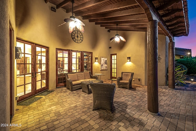 patio terrace at dusk with ceiling fan and french doors