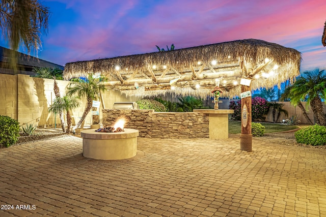 patio terrace at dusk with an outdoor fire pit