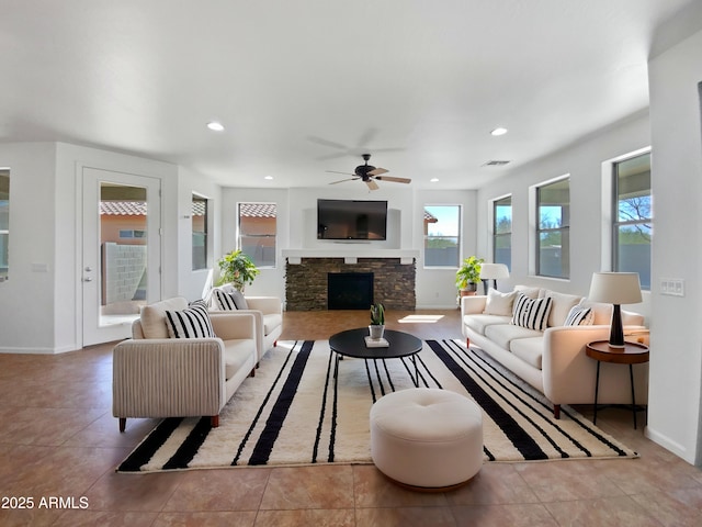 living area with baseboards, a fireplace, visible vents, and recessed lighting