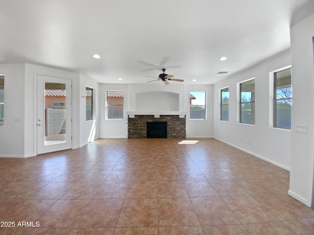 unfurnished living room featuring a stone fireplace, recessed lighting, a ceiling fan, and baseboards