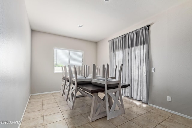 dining room with baseboards and light tile patterned flooring