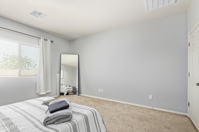 bedroom with baseboards, visible vents, and carpet floors