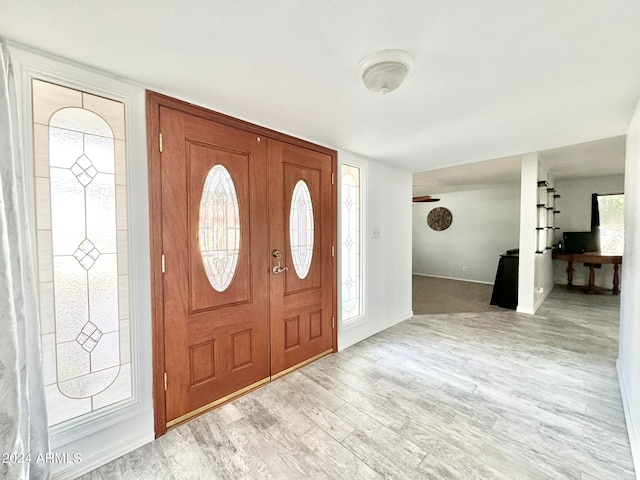 foyer entrance with light hardwood / wood-style flooring