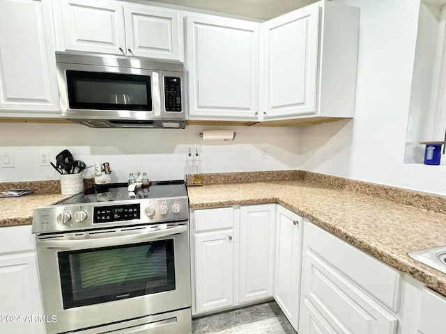 kitchen with stainless steel appliances and white cabinetry