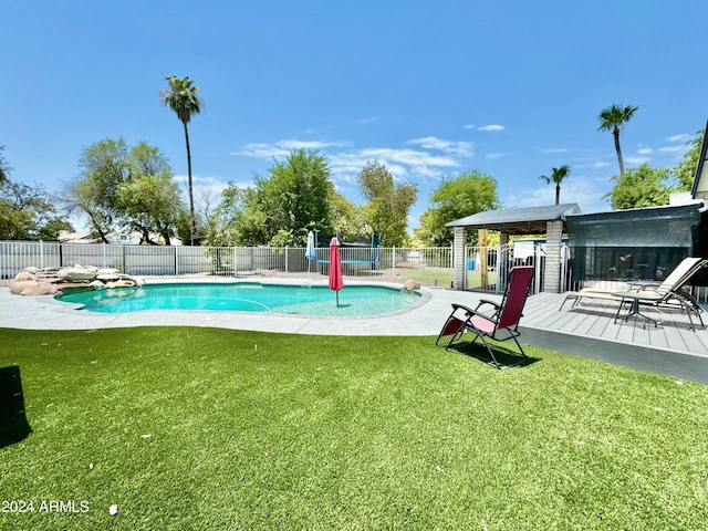 view of pool featuring a yard and a wooden deck