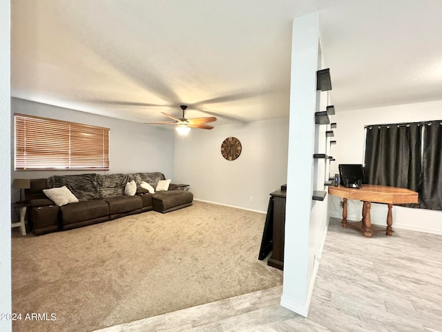 living room with ceiling fan and light colored carpet