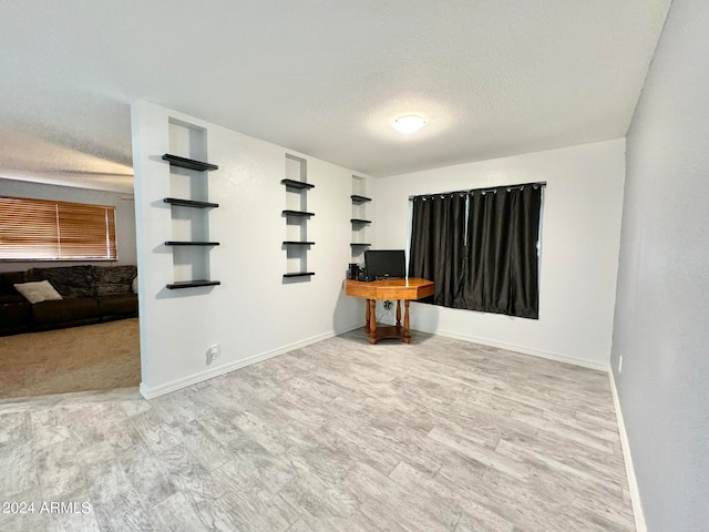 interior space with light hardwood / wood-style flooring and a textured ceiling