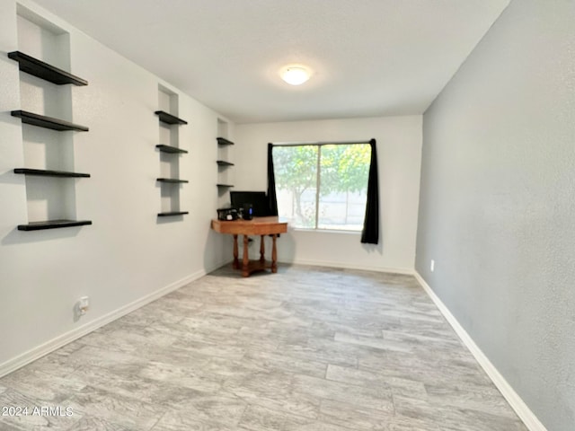 spare room featuring light hardwood / wood-style flooring