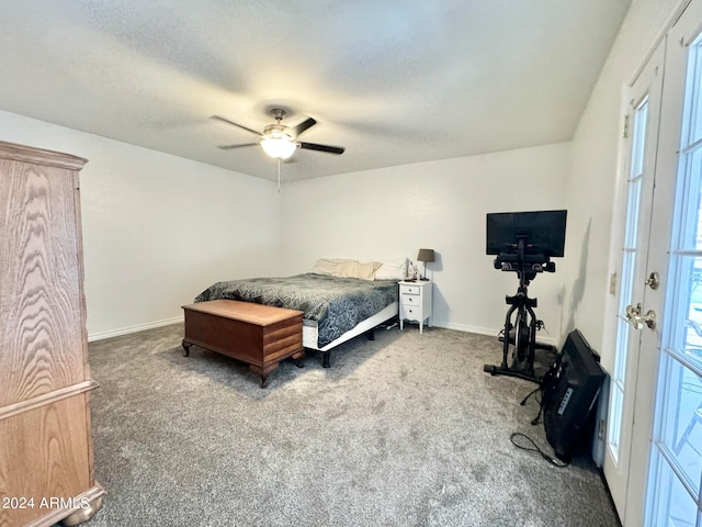 bedroom featuring a textured ceiling, dark colored carpet, and ceiling fan