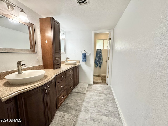 bathroom featuring vanity and a textured ceiling