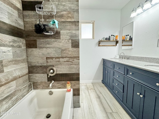 bathroom with wood-type flooring, vanity, and a washtub