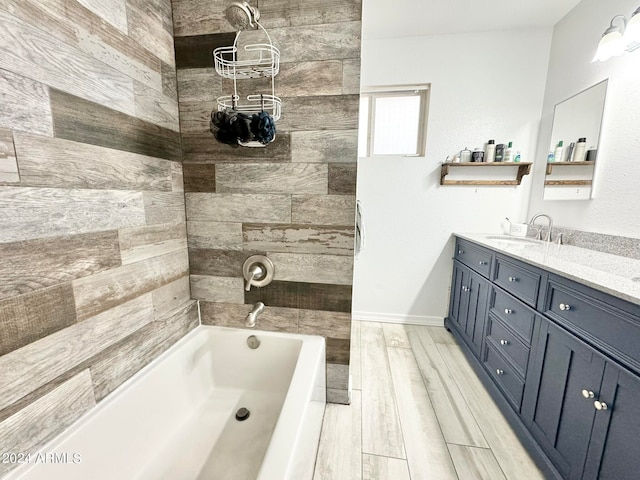 bathroom with wood-type flooring, vanity, and a bathtub