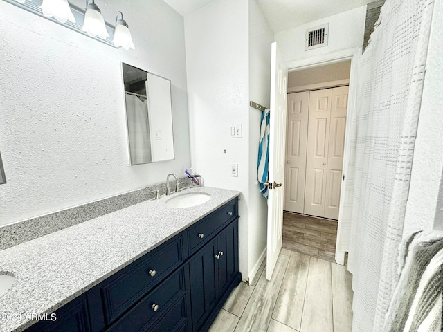 bathroom with wood-type flooring and vanity