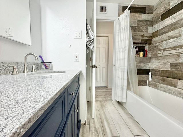 bathroom featuring vanity, shower / tub combo, and hardwood / wood-style floors