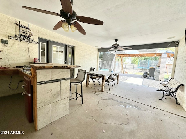 view of patio / terrace featuring ceiling fan and an outdoor bar