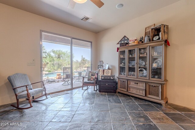 8606 E Arroyo Seco Rd, Scottsdale, AZ 85266 - sitting room featuring stone tile floors and ceiling fan
