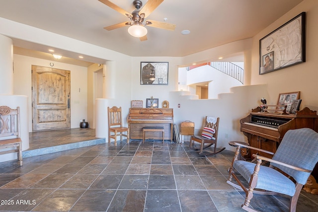8606 E Arroyo Seco Rd, Scottsdale, AZ 85266 - sitting room with stone tile floors and ceiling fan