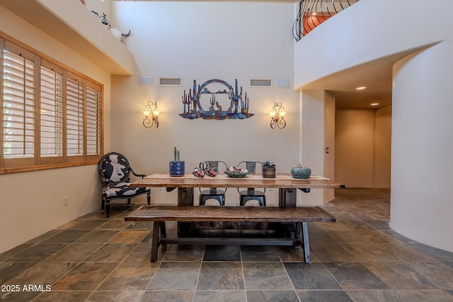 8606 E Arroyo Seco Rd, Scottsdale, AZ 85266 - dining area featuring stone finish floors and a high ceiling