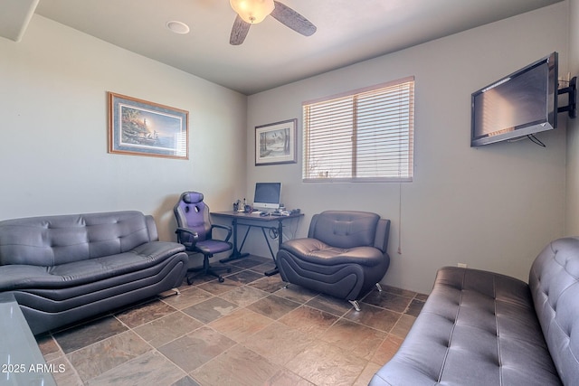 8606 E Arroyo Seco Rd, Scottsdale, AZ 85266 - living room featuring ceiling fan, stone finish flooring, and a desk