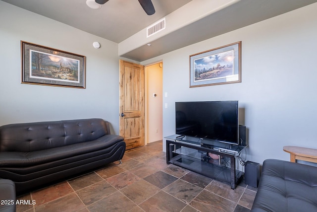 8606 E Arroyo Seco Rd, Scottsdale, AZ 85266 - living area featuring ceiling fan and dark stone finish floors