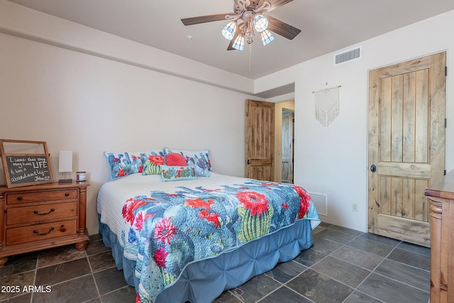 8606 E Arroyo Seco Rd, Scottsdale, AZ 85266 - bedroom with stone tile floors and a ceiling fan