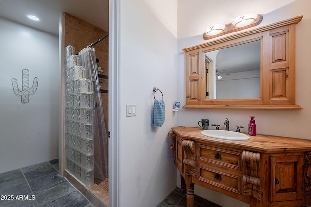 8606 E Arroyo Seco Rd, Scottsdale, AZ 85266 - bathroom featuring curtained shower, ceiling fan, stone finish floors, vanity, and recessed lighting