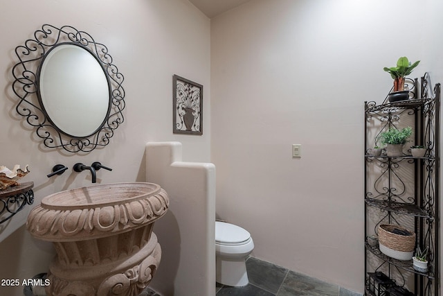 8606 E Arroyo Seco Rd, Scottsdale, AZ 85266 - half bathroom featuring stone finish floors and toilet