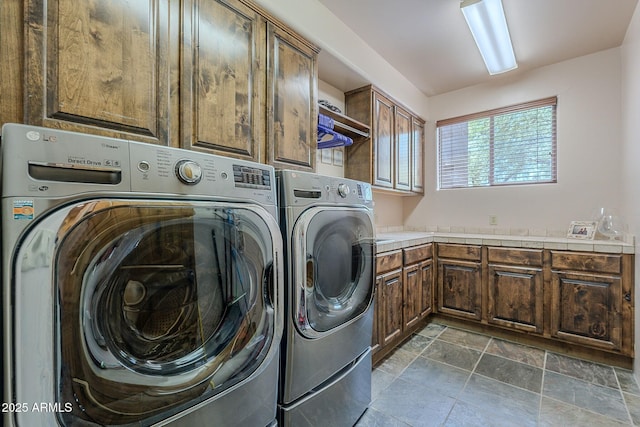 8606 E Arroyo Seco Rd, Scottsdale, AZ 85266 - laundry area featuring washing machine and dryer, cabinet space, and dark stone finish flooring