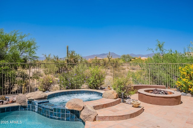 8606 E Arroyo Seco Rd, Scottsdale, AZ 85266 - view of pool featuring a fire pit, a mountain view, fence, a patio area, and a pool with connected hot tub